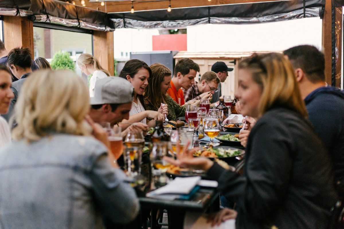 Friends sharing a long table dinner